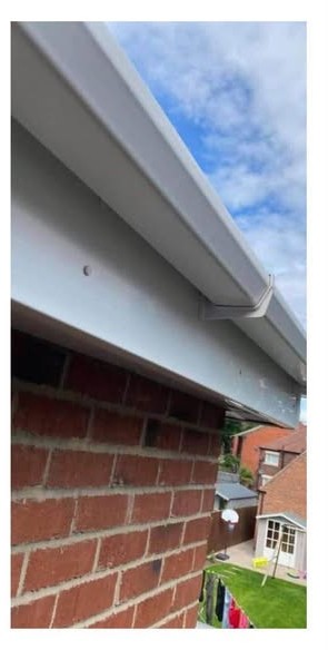 The same gutter and fascia cleaned back to white